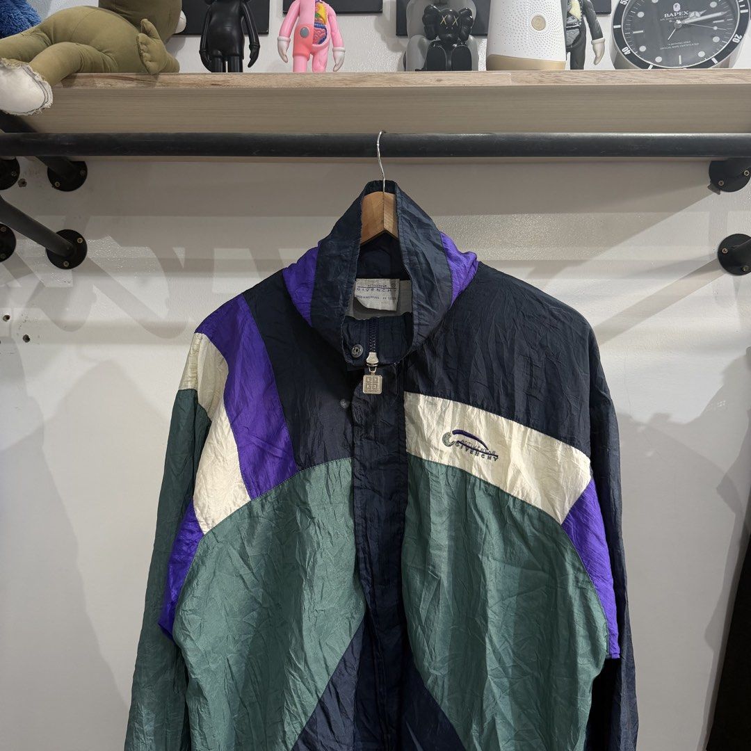 vintage 1990s Givenchy Activewear nylon windbreaker (Category: Coats, Jackets and Outerwear) located in Bambang. Submitted by heats777 (Listing ID 1460084659, Image 1). Description: Good condition Issue: Stains to be safe featuring a bold retro color-blocked design in black, green, and purple and embroidered script on chest Size: M.