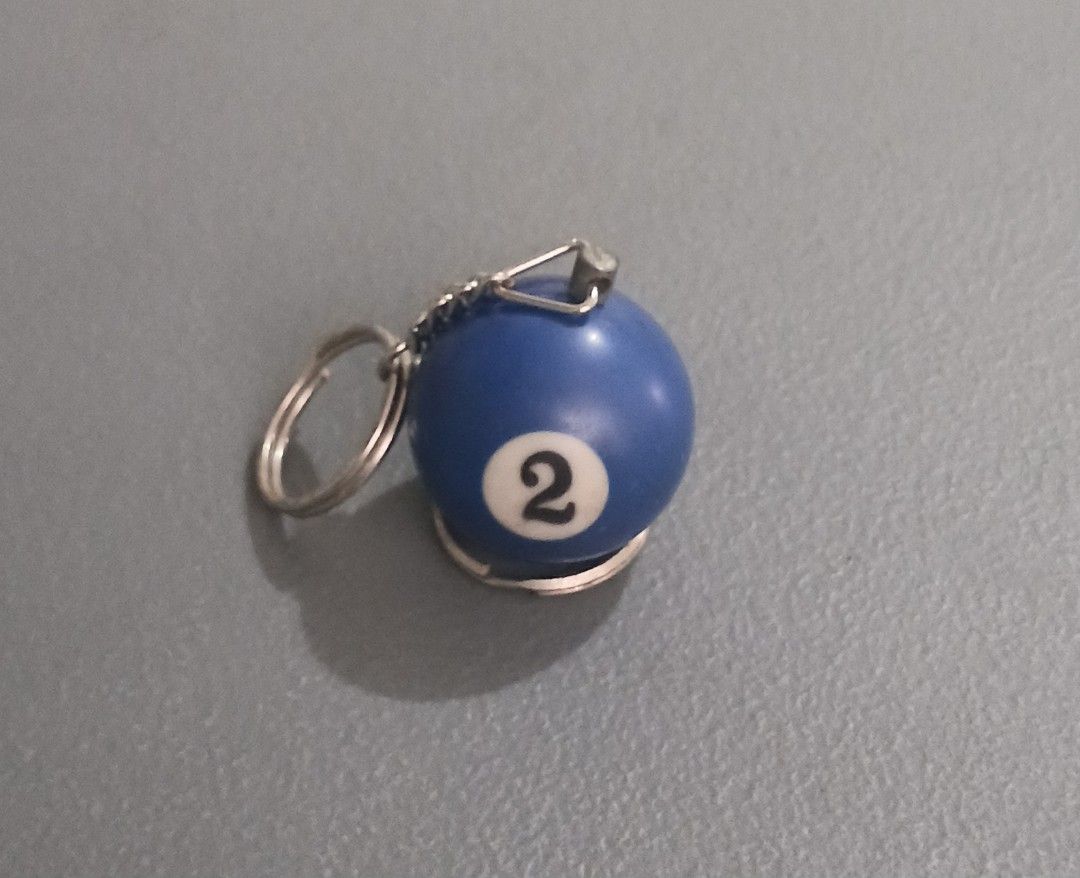 Vintage Blue Pool Ball Number 2 Keychain (Category: Character Goods) located in Bulacan. Submitted by honhonliz (Listing ID 1459918217, Image 1). Description: - Cool keychain shaped like a blue pool ball. - Features the number 2. - Comes with a durable metal ring and chain. - Ideal for personalizing your keys or bag. - A unique and stylish accessory..