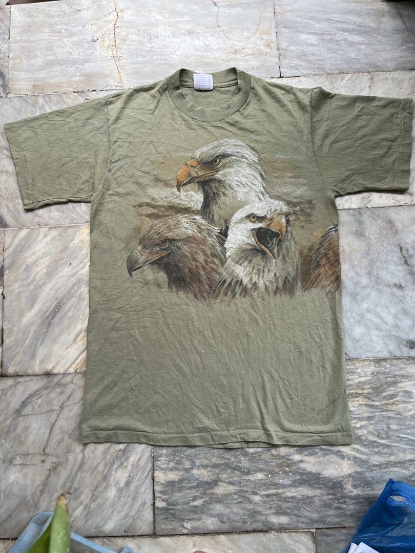 Vintage Eagle Tee (Category: Tshirts & Polo Shirts ) located in Camaligan. Submitted by thriftcouturebyaybs (Listing ID 1460066034, Image 1). Description: - Excellent Condition - Issue:see Last 2 pics - Single Stitch All over - Buyer Should Handle The Shipping Cost - W: 21 inch - L: 29 inch .