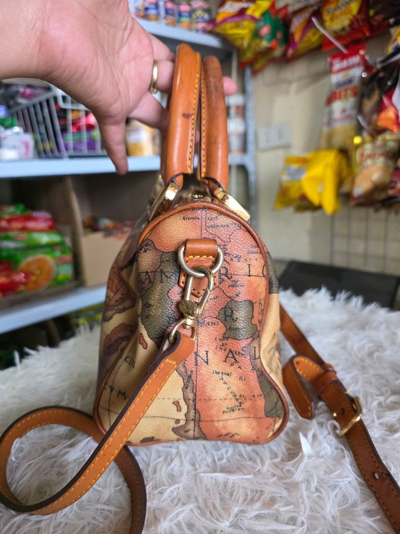 Vintage Map Print Bag (Category: Cross-body Bags) located in Lemery. Submitted by venus23 (Listing ID 1459932688, Image 2). Description: - Adorable satchel bag with a vintage world map print. - Features stylish tan leather trim and handles. - Accented with elegant gold hardware. - Comes with a detachable shoulder strap for versatile carrying. - Compact size: approximately 8 inches wide and 6 inches tall. - Ideal for travel adventures or chic ever