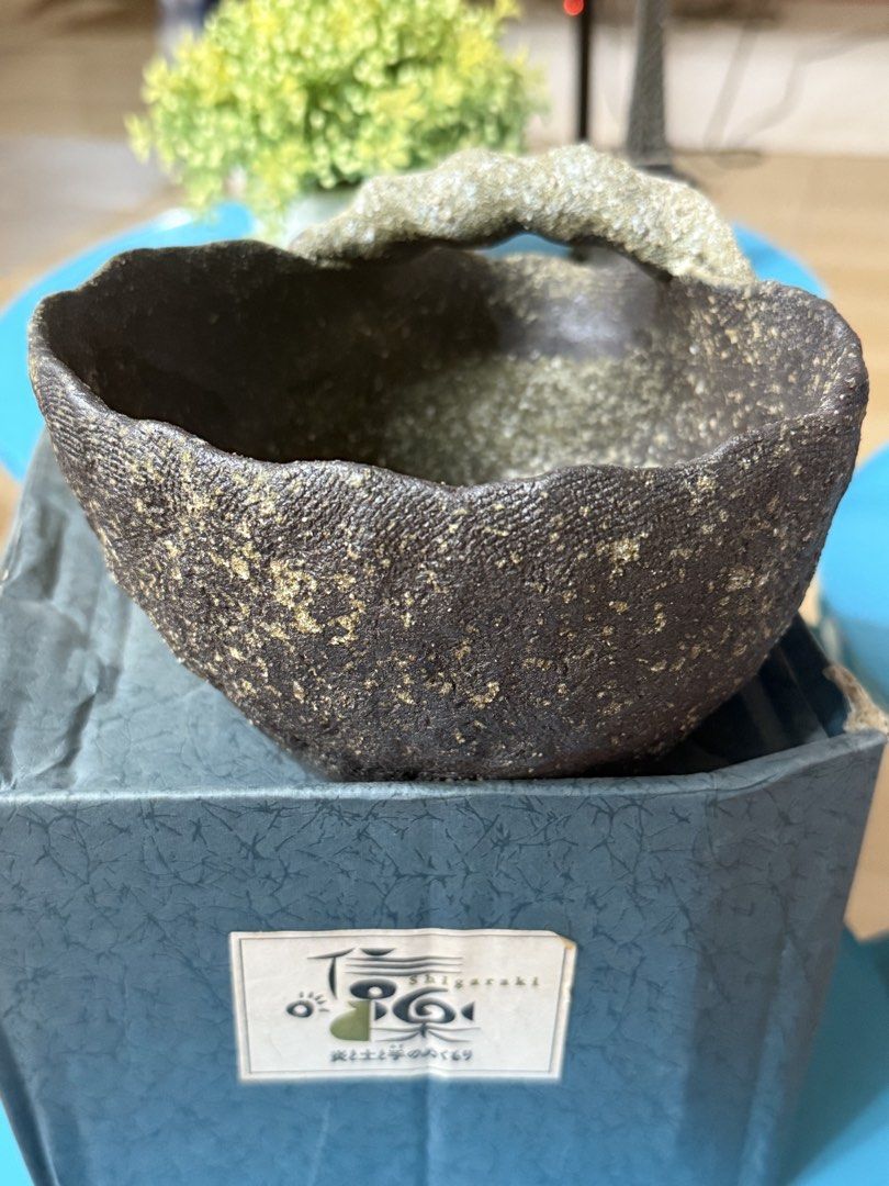 Vintage Shigaraki Ware Ceramic Bowl with Handle (Category: Vases & Decorative Bowls) located in Mandaluyong City. Submitted by ardzensthrift (Listing ID 1459961915, Image 2). Description: - Authentic Shigaraki ware ceramic bowl - Textured dark brown exterior with subtle gold speckles - Unique, natural stone-like finish on the handle - Comes with its original presentation box - Ideal for decorative display or as a distinctive serving dish.