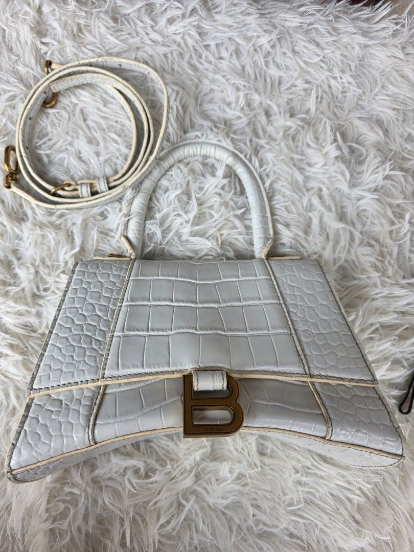 White Crocodile Embossed Hourglass Top Handle Bag (Category: Cross-body Bags) located in Lemery. Submitted by venus23 (Listing ID 1459922975, Image 2). Description: - White Hourglass Bag - Luxurious Crocodile Embossed Leather - Iconic Gold 'B' Hardware - Comes with Detachable Shoulder Strap - Interior is clean - Perfect statement accessory.