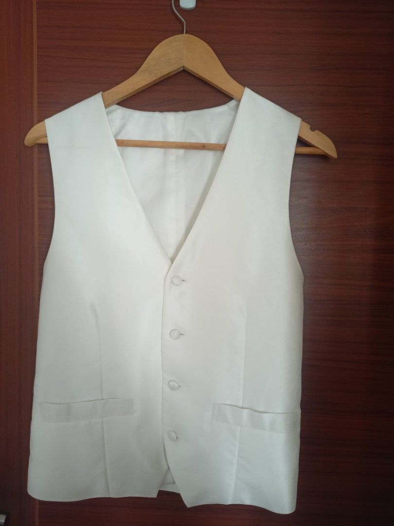 White Formal Vest Waistcoat (Category: Sleeveless) located in Quezon City. Submitted by fayelin011 (Listing ID 1459954979, Image 1). Description: - Classic white formal vest - Secure button front closure - Two functional front pockets - Adjustable strap at the back for a perfect fit - Ideal for weddings, parties, or completing your suit ensemble.