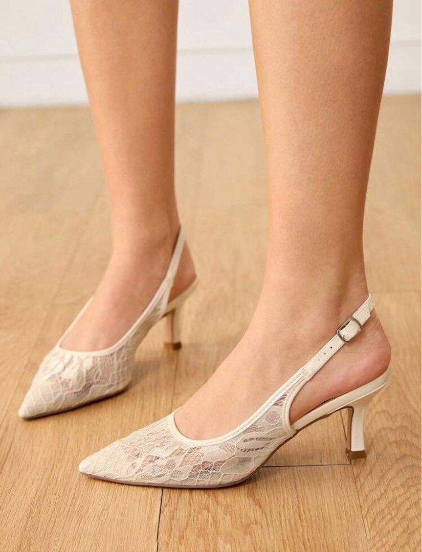 White Lace Slingback Heels with Buckle Strap (Category: Heels) located in Manila. Submitted by helpm3declutt3rrr (Listing ID 1460001908, Image 1). Description: - White lace slingback heels - Pointed toe design - Delicate lace overlay - Adjustable buckle strap at the heel - Low kitten heel - Ideal for weddings and special occasions.
