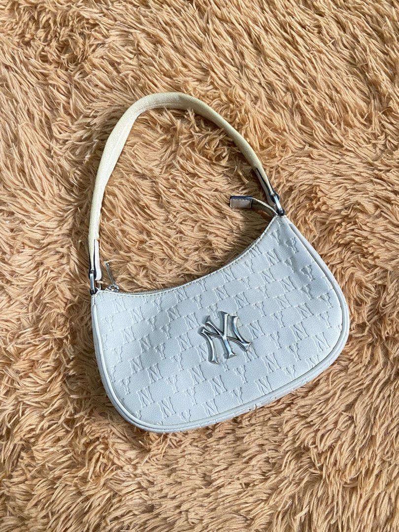 White NY Monogram Shoulder Bag (Category: Luxury Bags & Wallets) located in Manila. Submitted by thritingera25 (Listing ID 1460010161, Image 2). Description: - White shoulder bag with all-over NY monogram pattern - Features a silver NY logo on the front - Adjustable strap for comfortable wear - Perfect size for carrying your essentials - Clean and ready for its new owner.