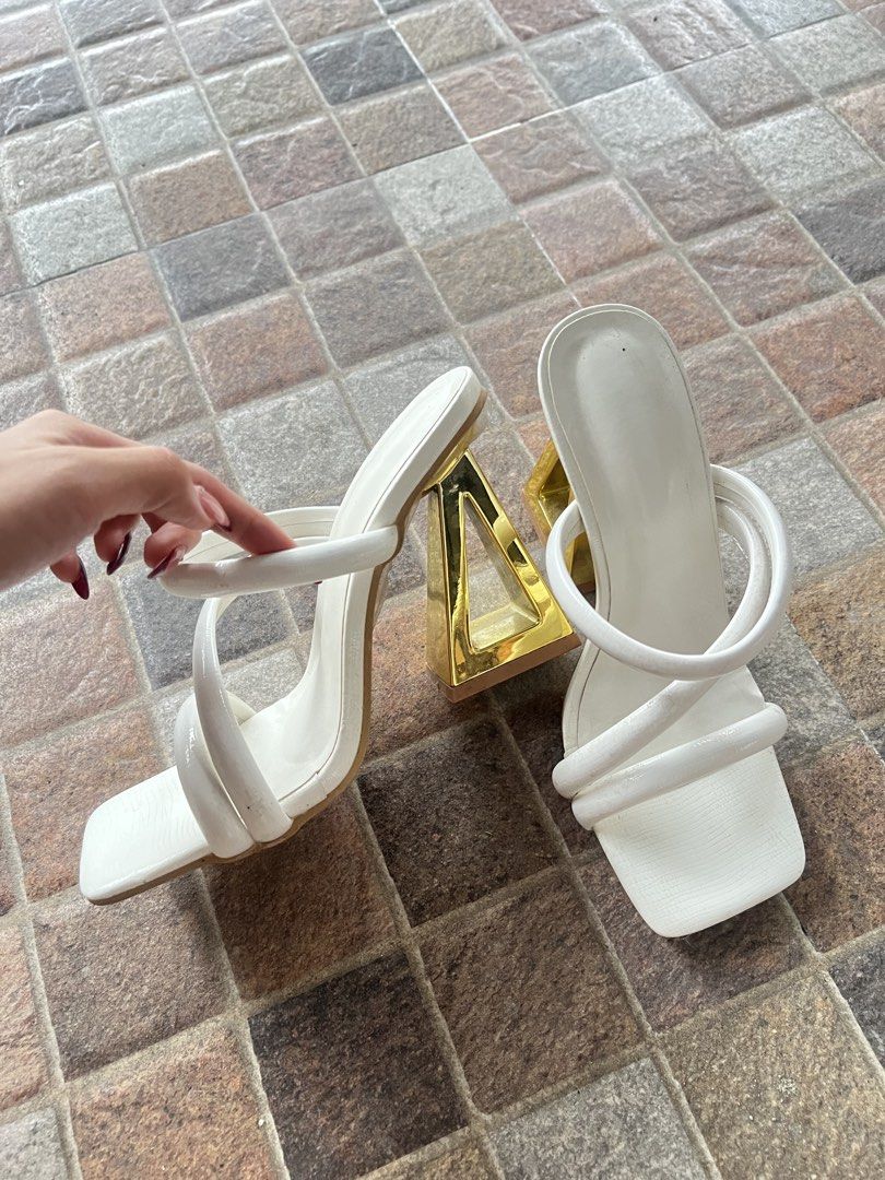 White Square Toe Heels with Gold Geometric Block Heels (Category: Heels) located in Manila. Submitted by saintnasti (Listing ID 1460088763, Image 2). Description: - White mule heels - Square toe - Unique gold geometric block heel - Strappy design across the foot - Protective plastic still attached to soles - Size: 37 - Ideal for elevating any outfit.