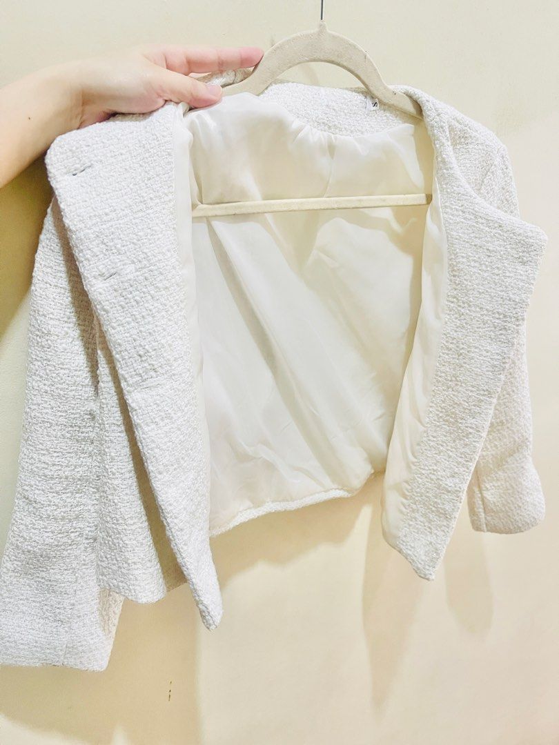 White Tweed Jacket Blazer (Category: Coats, Jackets and Outerwear) located in Quezon City. Submitted by prelovedluxe_ (Listing ID 1459933172, Image 3). Description: Elegant and timeless white open style tweed jacket featuring a textured woven finish. Designed with a structured, slightly cropped silhouette, round neckline, long sleeves, and flap pockets for a refined yet versatile look. The jacket is fully lined. Easy to dress up or down—pair it w