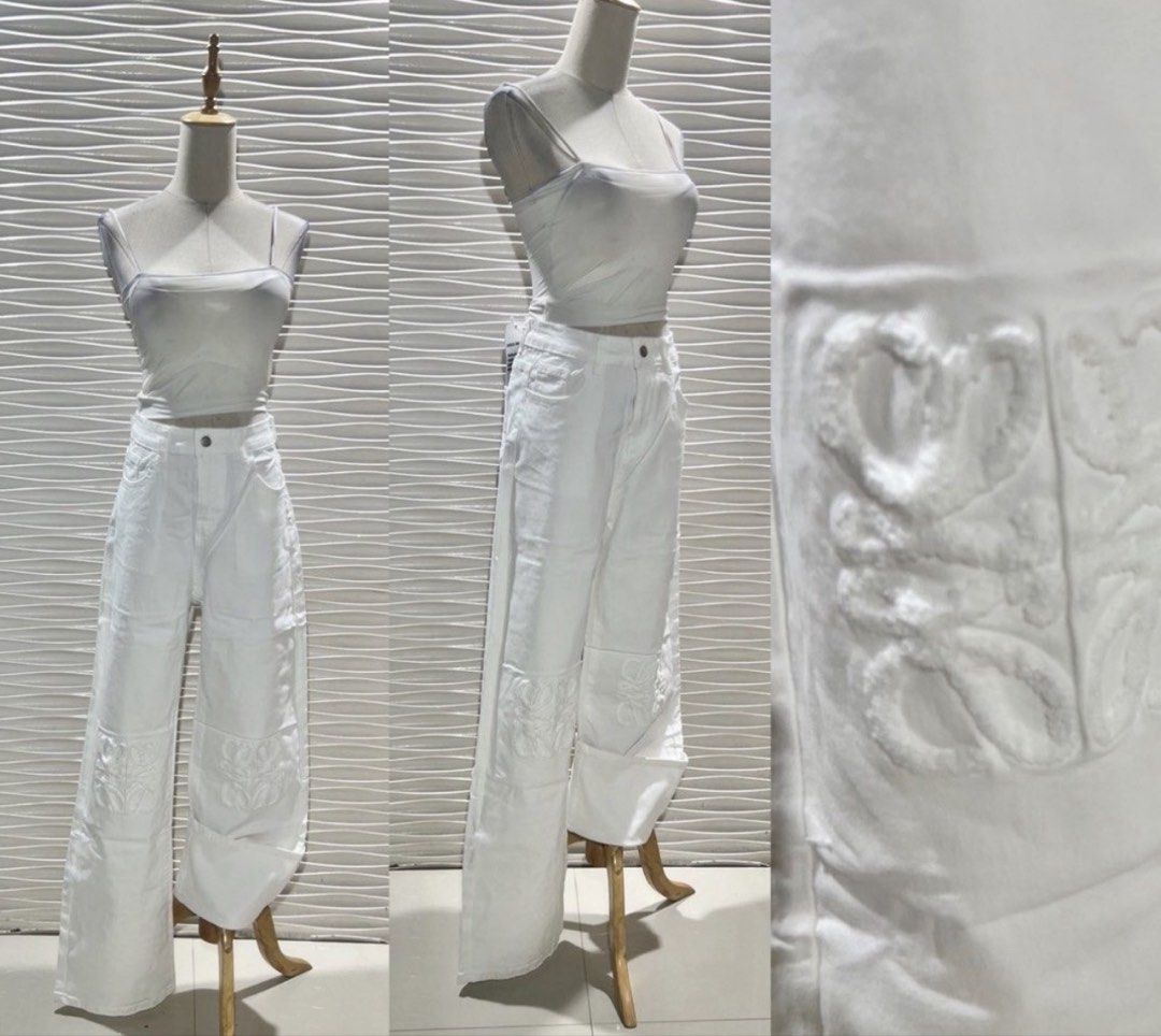 White Wide Leg Pants with Embossed Logo (Category: Other Bottoms) located in Bacolod City. Submitted by bhabissagal-05763 (Listing ID 1459928197, Image 1). Description: - White wide-leg pants - High-waisted style - Relaxed fit - Embossed logo detail on the front - Patchwork design on the legs - Button and zip closure.