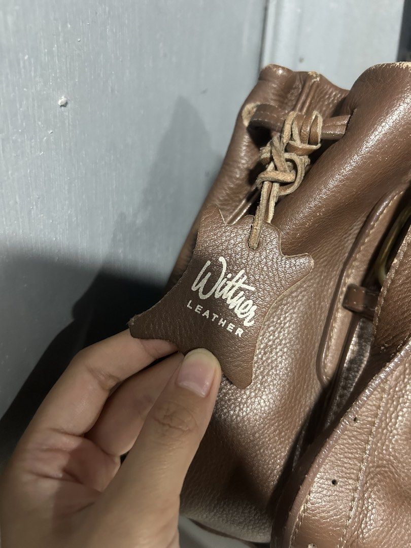 Wittner Leather Handbag - Brown (Category: Tote Bags) located in Manila. Submitted by luevy (Listing ID 1459963302, Image 2). Description: - Wittner brown handbag - Genuine leather - Drawstring closure - Minor signs of wear on top edges - Interior zippered pocket - Classic and versatile for everyday use.