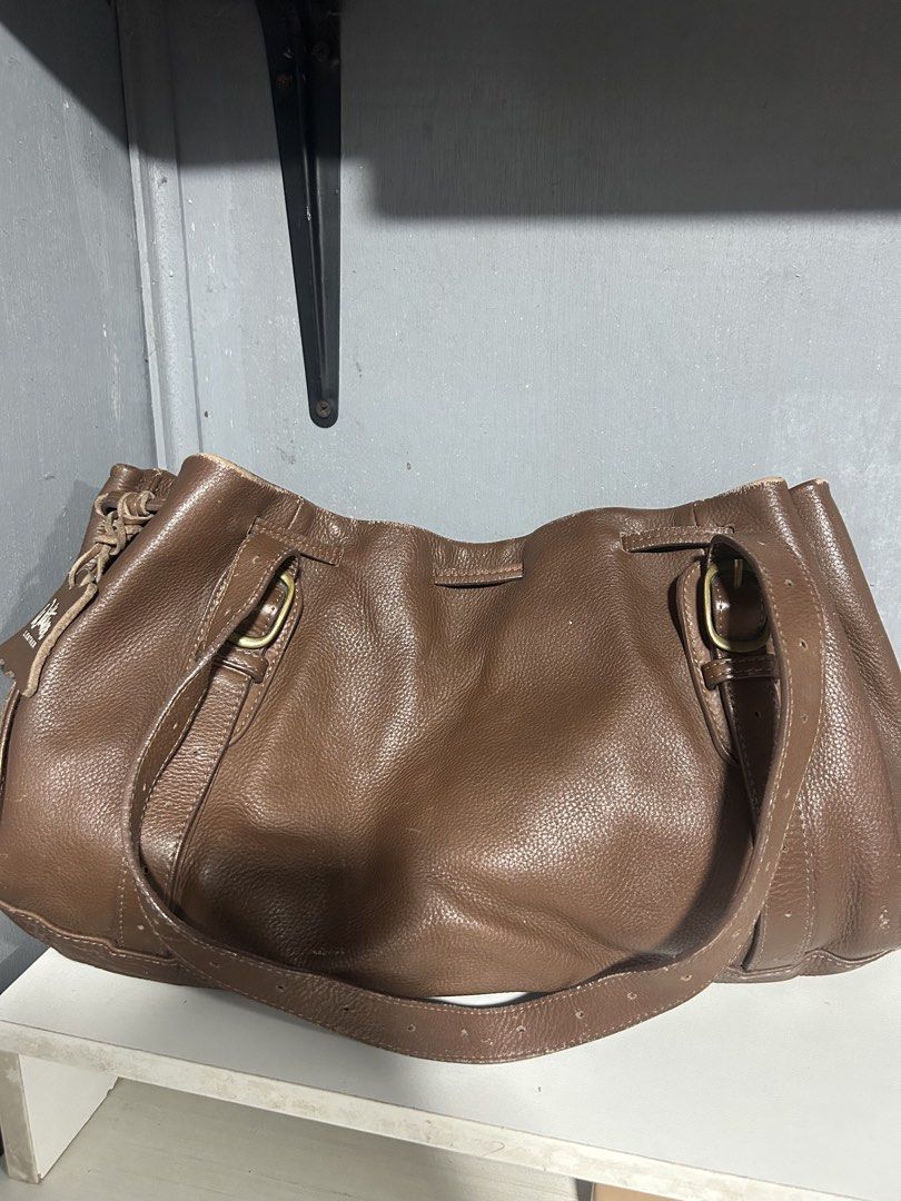 Wittner Leather Handbag - Brown (Category: Tote Bags) located in Manila. Submitted by luevy (Listing ID 1459963302, Image 1). Description: - Wittner brown handbag - Genuine leather - Drawstring closure - Minor signs of wear on top edges - Interior zippered pocket - Classic and versatile for everyday use.
