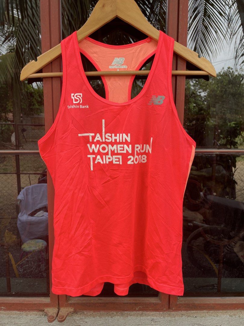 WOMENS RUNNING SHIRT (Category: Sleeveless) located in Quezon. Submitted by thriftedbyandie (Listing ID 1460029388, Image 1). Description: This is a bright orange-red New Balance running singlet from the 2018 Taishin Women Run Taipei event, featuring the Taishin Bank logo on the chest..