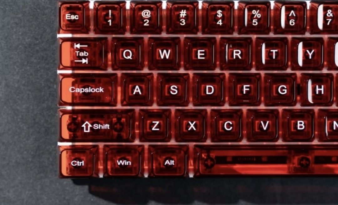 Womier Translucent Red Mechanical Keyboard Keycap Set (Category: Computer Keyboard) located in Quezon City. Submitted by manixbarba (Listing ID 1460078228, Image 2). Description: - Translucent red keycaps - Brand: Womier - Shine-through effect for enhanced aesthetics - Full keycap set for various keyboard layouts - Comes in original packaging - Perfect for keyboard customization.