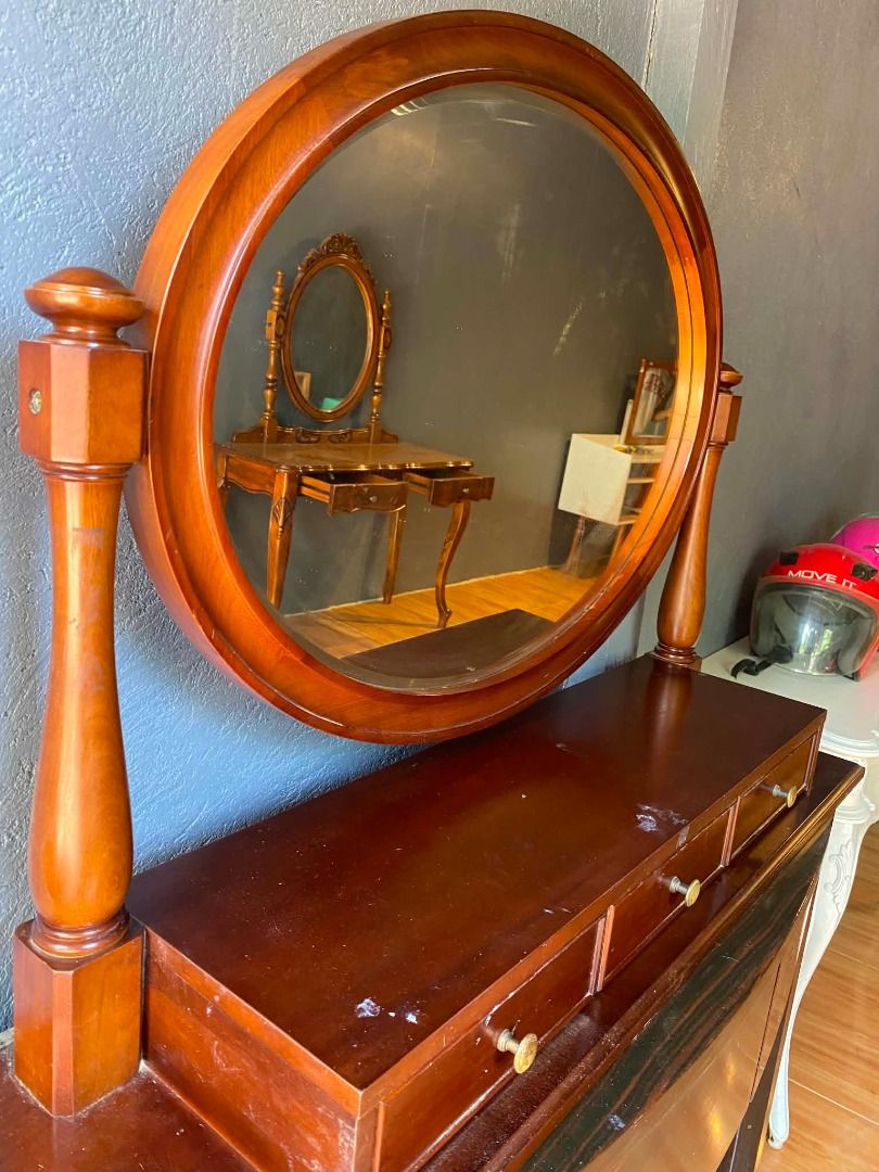 Wooden Oval Swivel Mirror for Dressing Table (Category: Tables & Sets) located in Minglanilla. Submitted by naquilagretchen (Listing ID 1460039772, Image 3). Description: - Wooden oval mirror with swivel function - Perfect for dressing tables or dressers - Three drawers with small knobs for storage - Rich, dark wood finish - Minor surface marks on drawer fronts - Ideal for creating a vanity setup.