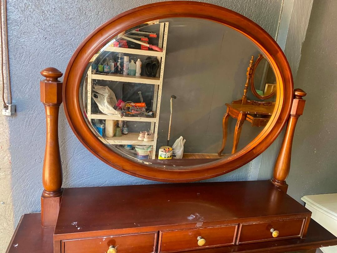 Wooden Oval Swivel Mirror for Dressing Table (Category: Tables & Sets) located in Minglanilla. Submitted by naquilagretchen (Listing ID 1460039772, Image 2). Description: - Wooden oval mirror with swivel function - Perfect for dressing tables or dressers - Three drawers with small knobs for storage - Rich, dark wood finish - Minor surface marks on drawer fronts - Ideal for creating a vanity setup.