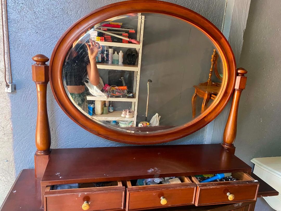 Wooden Oval Swivel Mirror for Dressing Table (Category: Tables & Sets) located in Minglanilla. Submitted by naquilagretchen (Listing ID 1460039772, Image 1). Description: - Wooden oval mirror with swivel function - Perfect for dressing tables or dressers - Three drawers with small knobs for storage - Rich, dark wood finish - Minor surface marks on drawer fronts - Ideal for creating a vanity setup.