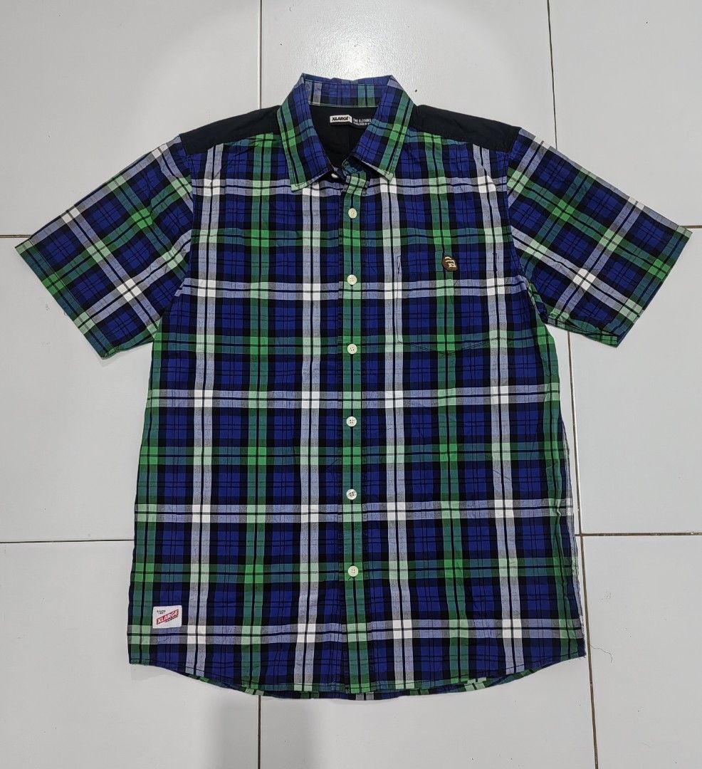 XLARGE Plaid Short Sleeve Shirt (Category: Tshirts & Polo Shirts ) located in Guihulngan. Submitted by wengweng41294 (Listing ID 1460032709, Image 1). Description: - XLARGE Short Sleeve Button-Up Shirt - Classic blue, green, and white plaid pattern - Stylish black accents on shoulders and back yoke - Subtle embroidered logo on chest pocket - Made from comfortable 100% cotton - Perfect for everyday casual wear - Size XL (22W 30L) - No issue. Excel