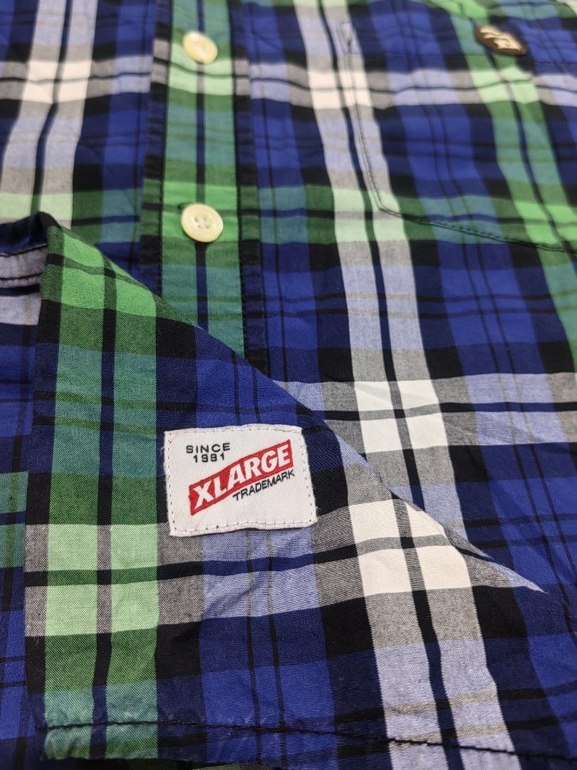 XLARGE Plaid Short Sleeve Shirt (Category: Tshirts & Polo Shirts ) located in Guihulngan. Submitted by wengweng41294 (Listing ID 1460032709, Image 3). Description: - XLARGE Short Sleeve Button-Up Shirt - Classic blue, green, and white plaid pattern - Stylish black accents on shoulders and back yoke - Subtle embroidered logo on chest pocket - Made from comfortable 100% cotton - Perfect for everyday casual wear - Size XL (22W 30L) - No issue. Excel