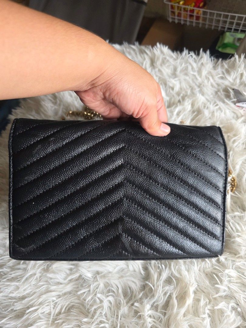 YSL Black Chevron Wallet (Category: Cross-body Bags) located in Lemery. Submitted by venus23 (Listing ID 1460025649, Image 2). Description: - black YSL wallet - Elegant chevron stitching - Signature gold YSL logo on front - Interior: Card slots and zipped compartment - Detachable chain strap included - Made from premium leather - Ideal for carrying essentials.