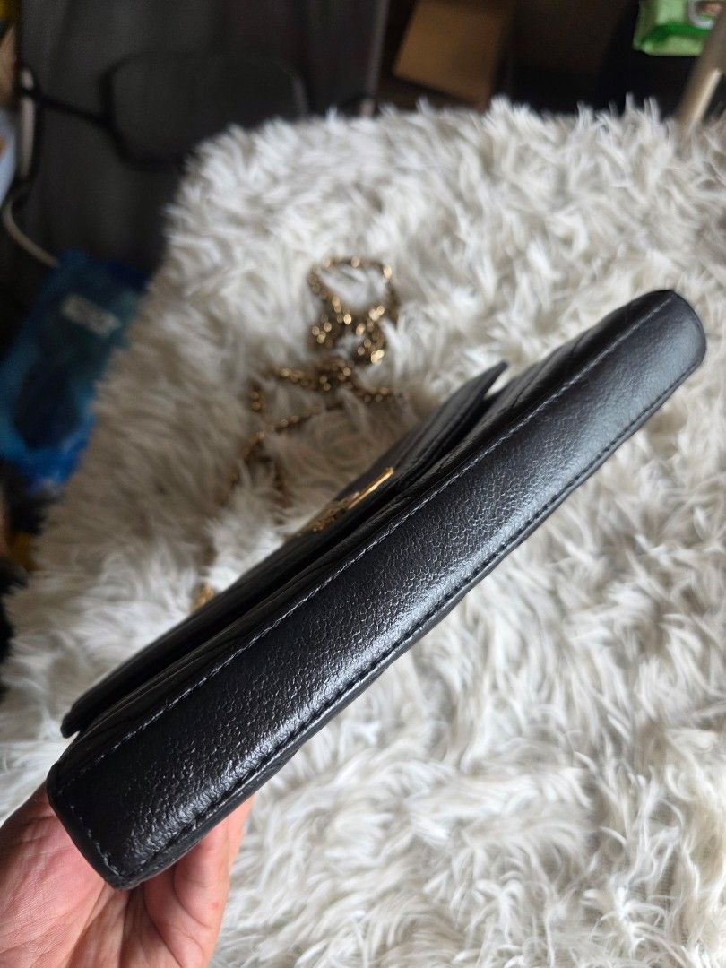 YSL Black Chevron Wallet (Category: Cross-body Bags) located in Lemery. Submitted by venus23 (Listing ID 1460025649, Image 3). Description: - black YSL wallet - Elegant chevron stitching - Signature gold YSL logo on front - Interior: Card slots and zipped compartment - Detachable chain strap included - Made from premium leather - Ideal for carrying essentials.