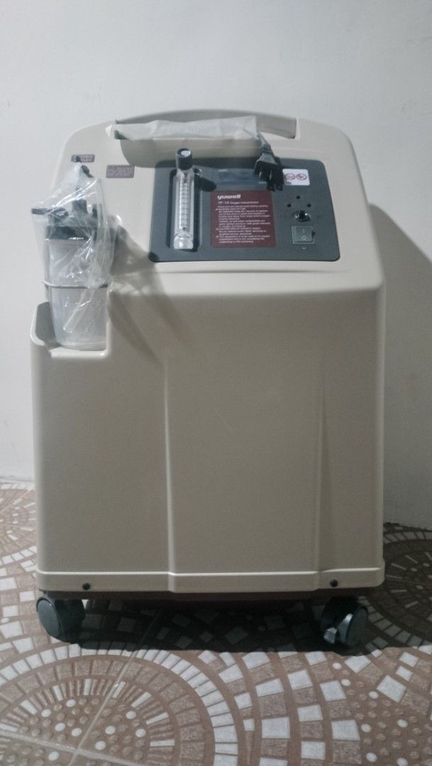 Yuwell 7F-10 Oxygen Concentrator (Category: Medical Supplies & Tools) located in Manila. Submitted by jchristiae40763 (Listing ID 1459902782, Image 1). Description: - Yuwell 7F-10 Oxygen Concentrator - Equipped with wheels for easy mobility - Includes humidifier bottle and tubing - Attached power cord - Features oxygen outlet and filter compartment - Unit is ready for immediate use.