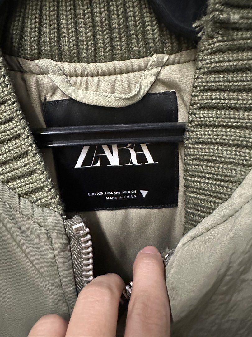 Zara Bomber Jacket Khaki Green XS (Category: Coats, Jackets and Outerwear) located in Manila. Submitted by joejoe0710 (Listing ID 1460074284, Image 2). Description: - Zara Khaki Green Bomber Jacket - Size: XS - Unique patchwork design - Distressed details for a cool vibe - Ribbed collar, cuffs, and hem - Zip-up front with convenient pockets - Ideal for stylish layering - Used once in a trip.