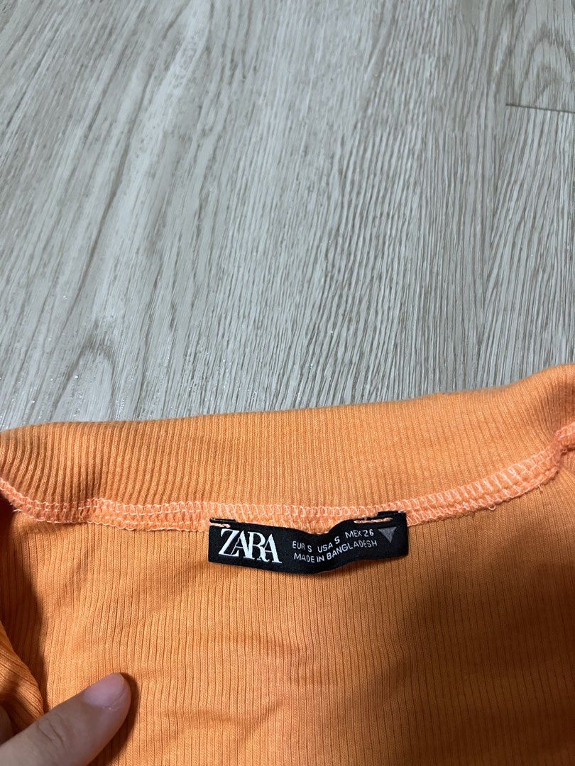 Zara Orange Ribbed Half Zip Cropped Top (Category: Blouses) located in Taytay. Submitted by j1123 (Listing ID 1460047402, Image 2). Description: - Zara orange ribbed cropped top - Short sleeves - Collared neckline - Half zip closure - Measurements: Length approx 16 inches, Pit to pit approx 14 inches - Made in Bangladesh - Ideal for casual wear.