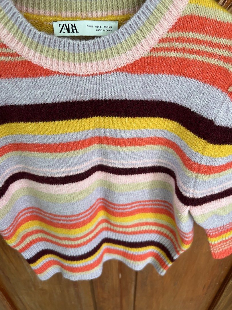 Zara Striped Puff Sleeve Knit Sweater (Category: Longsleeves) located in San Fernando. Submitted by prettyfinds2021 (Listing ID 1460028552, Image 2). Description: - Cute striped knit sweater from Zara - Features puff sleeves and a cropped fit - Colorful stripes: orange, yellow, pink, blue, and burgundy - Versatile for layering or wearing alone - Pairs well with jeans or skirts.