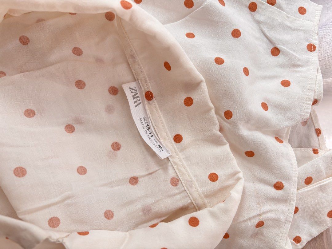 Zara White Polka Dot Tie Front Shirt (Category: Blouses) located in Manila. Submitted by mitzdcstr6 (Listing ID 1459980169, Image 3). Description: - Chic white shirt with charming brown polka dots - Short sleeves and classic collared neckline - Trendy tie-front detail at the hem - Relaxed fit for ultimate comfort - Effortlessly stylish for everyday casual wear.