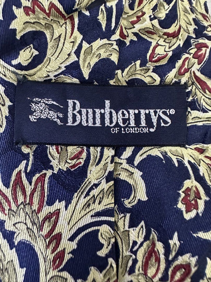 100% Silk Tie with Floral Pattern (Category: Ties) located in Manila. Submitted by declutterpromax (Listing ID 1460199110, Image 3). Description: - Color: Navy Blue - Pattern: Gold and Red Floral - Material: 100% Silk - Origin: Tag shows Japanese text - Length: Approximately 57 inches - Occasion: Ideal for formal events or adding elegance to any outfit.