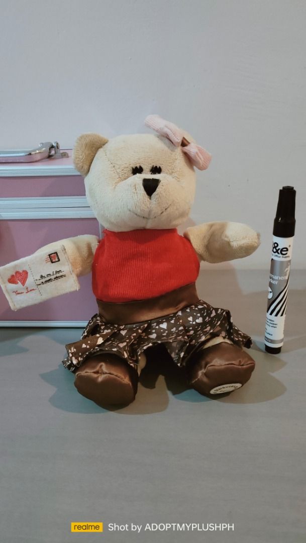 2011 Starbucks Bearista Bear (102nd Edition) (Category: Plushies & Soft Toys) located in Taguig. Submitted by adopt.my.plush.ph (Listing ID 1460233690, Image 1). Description: 2011 Starbucks Bearista Bear (102nd Edition) released for Valentine's Day, featuring a light brown plush body, a pink hair bow, a red top, and a heart-patterned skirt holding a love letter tag ‼️Last Price (LP) Posted. Fixed. Non-negotiable. Not subject to a bundle price. *a