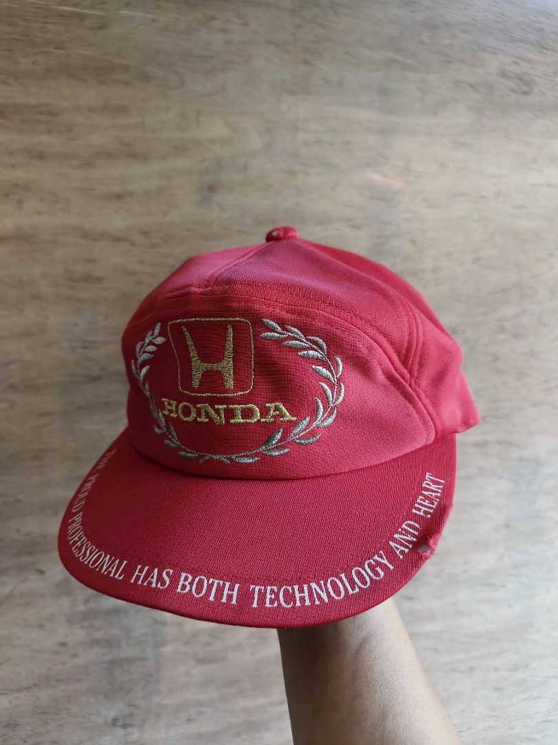 80's Honda Racing cap (Category: Caps & Hats) located in Davao. Submitted by vndrgd (Listing ID 1460187679, Image 1). Description: - Red Honda cap - Features Honda logo with laurel wreath design - Brim text: "THE PROUD PROFESSIONAL HAS BOTH TECHNOLOGY AND HEART" - Ideal for Honda enthusiasts.