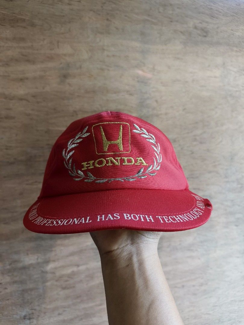 80's Honda Racing cap (Category: Caps & Hats) located in Davao. Submitted by vndrgd (Listing ID 1460187679, Image 3). Description: - Red Honda cap - Features Honda logo with laurel wreath design - Brim text: "THE PROUD PROFESSIONAL HAS BOTH TECHNOLOGY AND HEART" - Ideal for Honda enthusiasts.