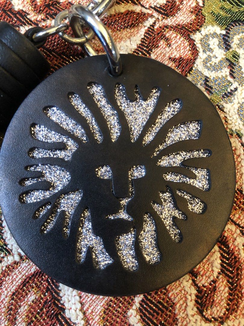 💯 Anne Klein Leather Tassel Keychain (Category: Luxury Accessories) located in Lapu Lapu. Submitted by maro8 (Listing ID 1460185568, Image 2). Description: - 💯 Anne Klein leather tassel keychain. - Featuring a stylized lion medallion, which represents the brand’s iconic logo. - Circular leather fob embossed with a metallic glitter lion head. - Silver-tone hardware. .