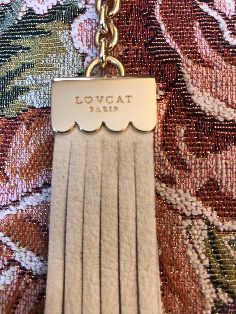 💯 Lovcat Paris Tassel (Category: Luxury Accessories) located in Lapu Lapu. Submitted by maro8 (Listing ID 1460183841, Image 2). Description: - Cream leather tassel keychain / bag charm from the French-inspired fashion brand Lovcat Paris. - Gold-tone hardware clasp and a scalloped metallic cap engraved with the brand’s logo..