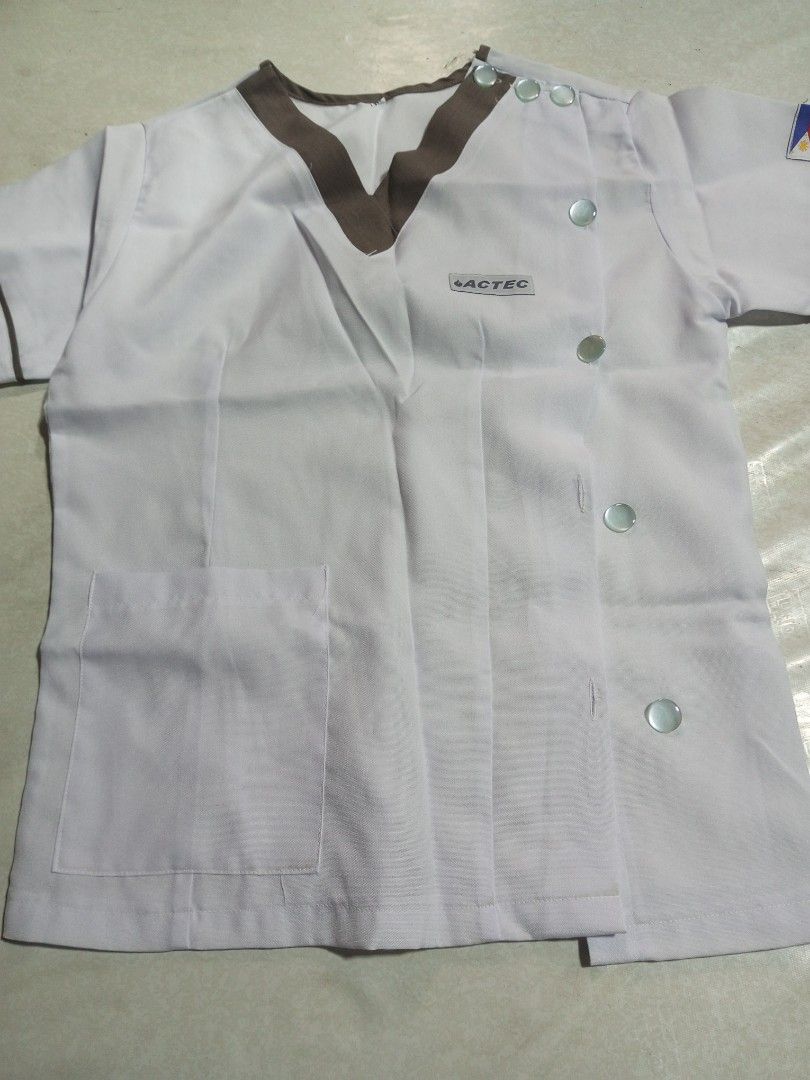 ACTEC White Scrub Suit Top and Pants (Category: Sets or Coordinates) located in Malolos. Submitted by radapostol (Listing ID 1460162088, Image 1). Description: - White scrub suit set (top and pants) - Top features stylish brown trim and side buttons - Pants have a comfortable elastic waistband - Ideal for medical and nursing students.