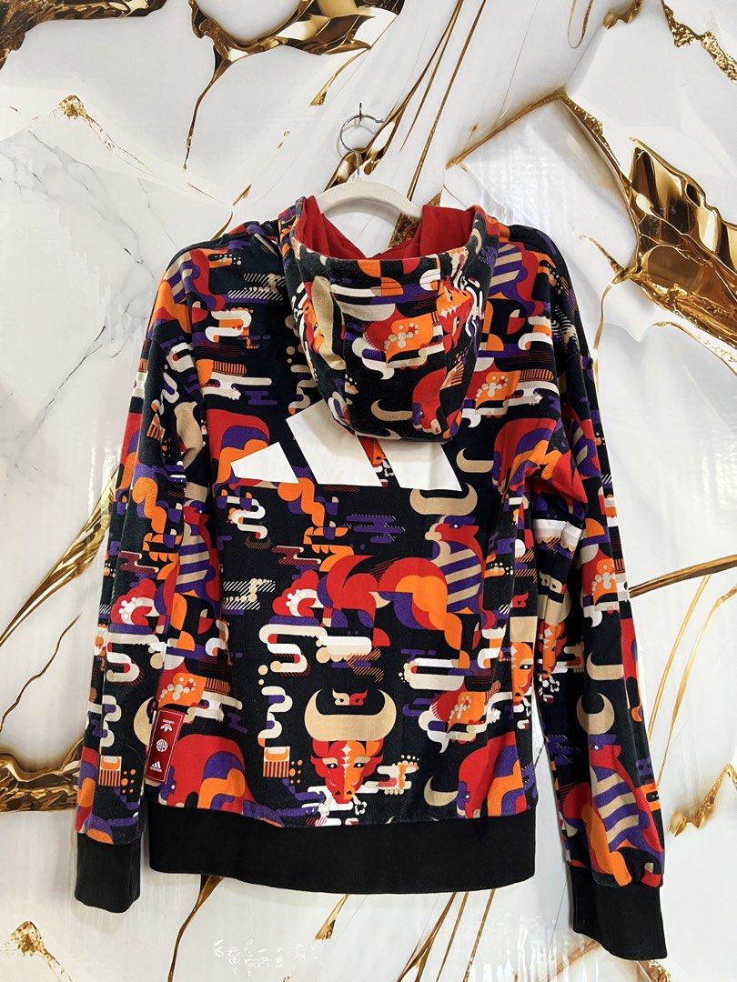 Adidas All Over Print Hoodie (Category: Hoodies) located in Cavite. Submitted by zacharyyy__ (Listing ID 1460154606, Image 2). Description: - Authentic Adidas hoodie - Unique all-over graphic print - Vibrant red, orange, and purple designs on a black base - Features a comfortable hood - Convenient front pocket - Ideal for casual wear and making a bold statement - Size 17 w x 25 1/2 L size S on tag 450 only 📍gma cavite.