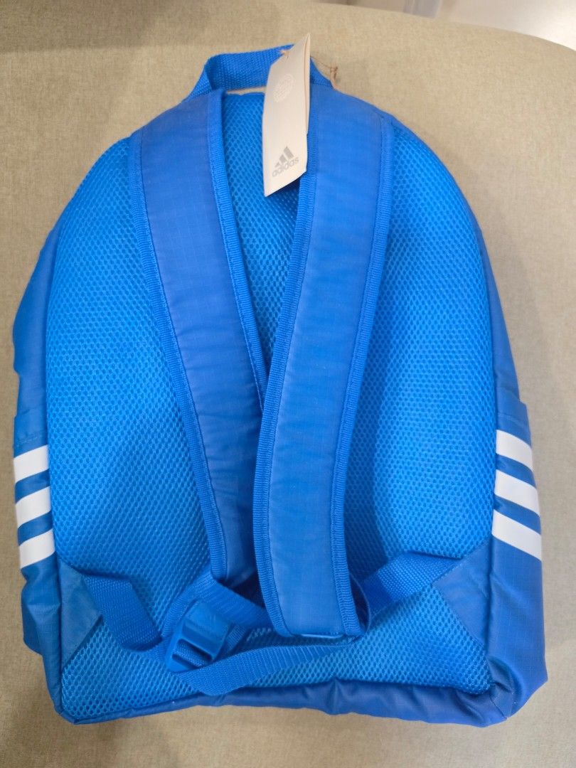 Adidas Backpack (Category: Backpacks) located in Manila. Submitted by leap888.leap888 (Listing ID 1460250173, Image 2). Description: - Blue Adidas backpack with iconic white stripes - 100% Authentic / Original and Brand New - Front zip pocket for easy access - Padded straps for comfortable carrying - Features 'END PLASTIC WASTE' tag - Size: NS (32cm x 47cm x 15cm) - Article number: HC7257 - Model number: G1990 - Ideal for everyday use, school, or