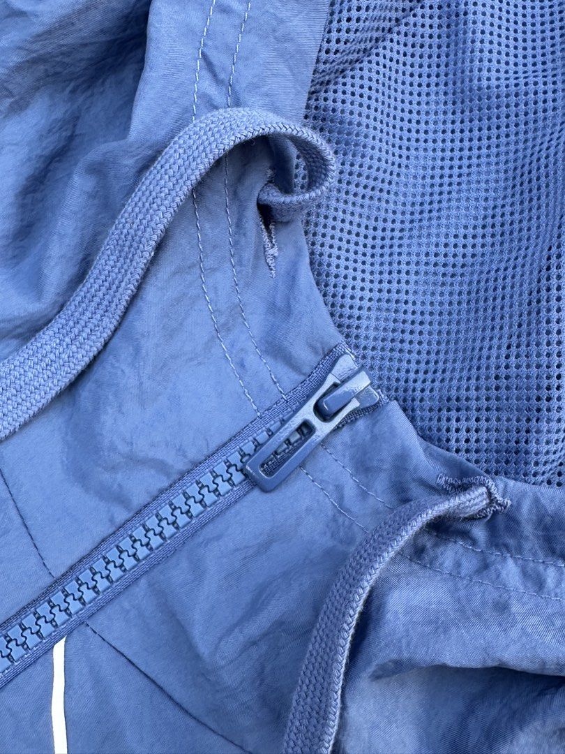 Adidas Blue Windbreaker Jacket with Large Logo (Category: Coats, Jackets and Outerwear) located in Padada. Submitted by jevanie1234 (Listing ID 1460269417, Image 3). Description: - Blue Adidas windbreaker jacket - Size: A/2XL - Features a hood and zip closure - Two zip pockets on the front - Large white Adidas logo across the front - Mesh lining inside - Made in Indonesia.