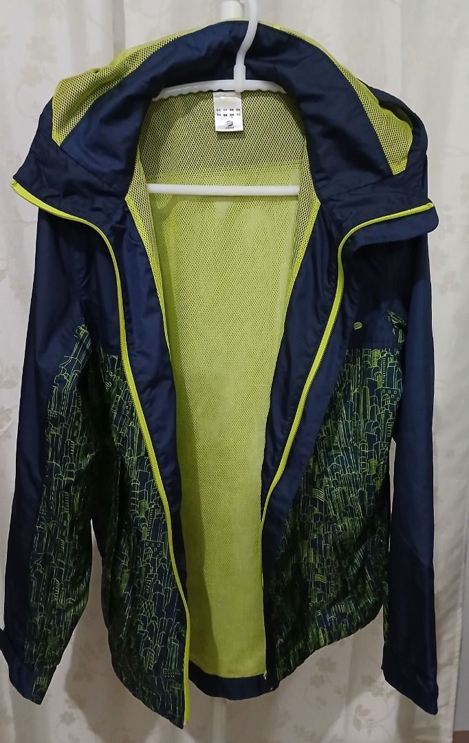Adidas Neo Label Hooded Windbreaker Jacket (Category: Coats, Jackets and Outerwear) located in Makati City. Submitted by chamarket.2022 (Listing ID 1460253187, Image 2). Description: Navy blue Adidas windbreaker with a cool lime green city graphic print. Hooded design. Mesh lining inside. Size S. Great for light rain or wind protection. Perfect for casual wear or sports. Material: 100% polyester Note: faded design at the lower back of jacket..