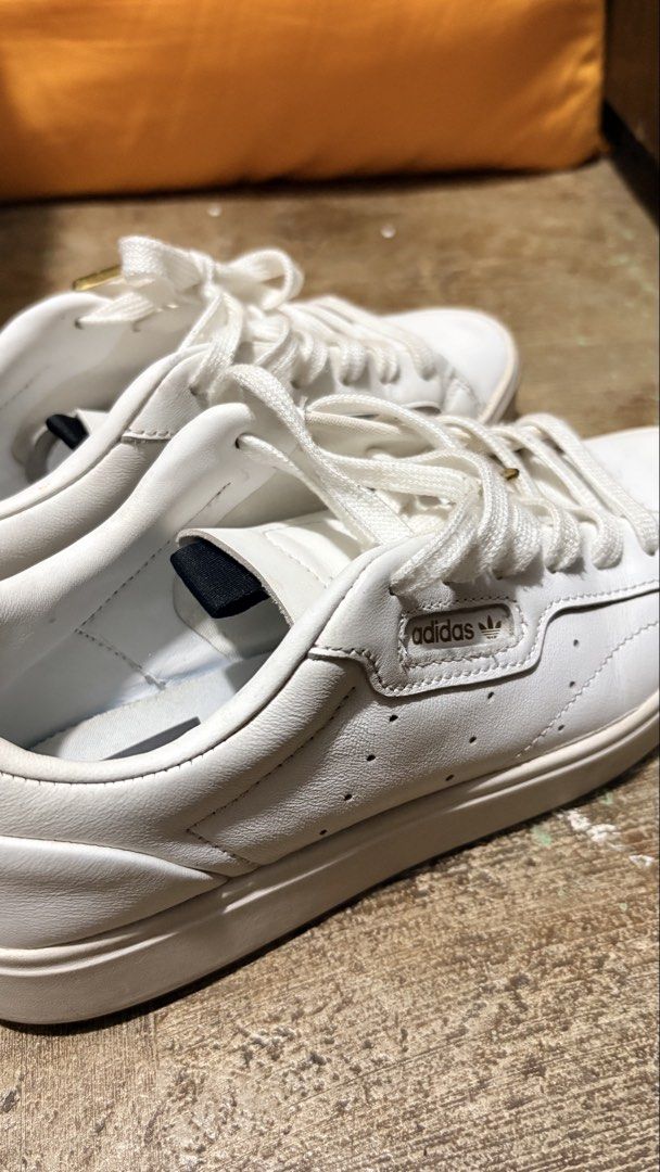 Adidas Sleek Super White Leather Sneakers (Category: Sneakers) located in Manila. Submitted by cleverriver-4879 (Listing ID 1460238797, Image 2). Description: - Classic white Adidas sneakers - Genuine leather material - Lace-up closure - Super clean and versatile for everyday wear - Minor scuffs on the sole from normal use - Plenty of life remaining.
