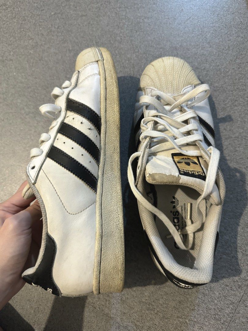 Adidas Superstar White Black Stripes Shell Toe Sneakers (Category: Casual Shoes) located in Manila. Submitted by trishyyy_ (Listing ID 1460222507, Image 2). Description: - Classic Adidas Superstar sneakers - Color: White with black stripes - Iconic shell toe design - Size: 10 US Men - Plenty of life left for casual wear.