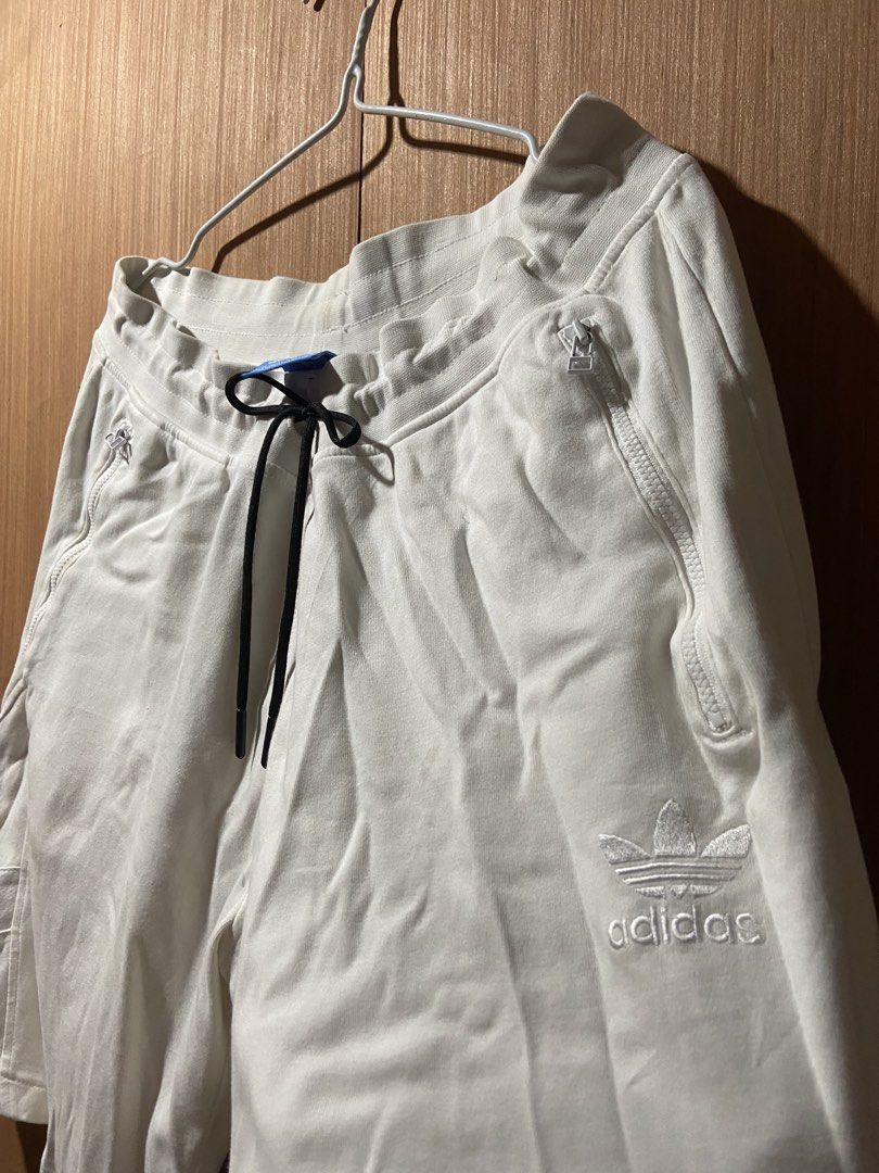Adidas White Shorts with Zip Pockets and Drawstring (Category: Shorts) located in Cagayan de Oro. Submitted by mindanao_thrifters (Listing ID 1460232871, Image 2). Description: - White Adidas shorts - Zip pockets on sides and back - Adjustable drawstring waist - Embroidered Adidas logo on leg and back - Comfortable and stylish for casual wear.