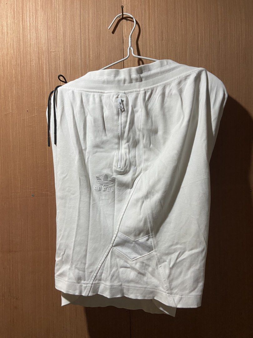 Adidas White Shorts with Zip Pockets and Drawstring (Category: Shorts) located in Cagayan de Oro. Submitted by mindanao_thrifters (Listing ID 1460232871, Image 3). Description: - White Adidas shorts - Zip pockets on sides and back - Adjustable drawstring waist - Embroidered Adidas logo on leg and back - Comfortable and stylish for casual wear.