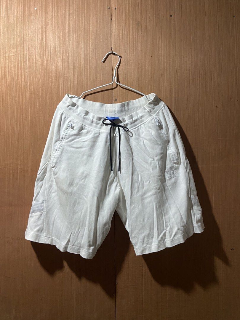 Adidas White Shorts with Zip Pockets and Drawstring (Category: Shorts) located in Cagayan de Oro. Submitted by mindanao_thrifters (Listing ID 1460232871, Image 1). Description: - White Adidas shorts - Zip pockets on sides and back - Adjustable drawstring waist - Embroidered Adidas logo on leg and back - Comfortable and stylish for casual wear.