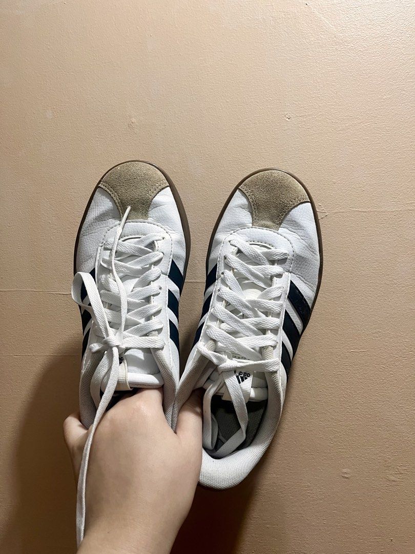 Adidas White Sneakers (Category: Sneakers) located in Manila. Submitted by _declutterbyleb (Listing ID 1460211956, Image 1). Description: - Classic white Adidas sneakers - black stripes for a sporty look - Suede toe cap detail for added texture - Durable brown rubber sole - Lace-up closure for a secure fit - Made in Vietnam - Size: US 6 / UK 4.5 / FR 37.5.