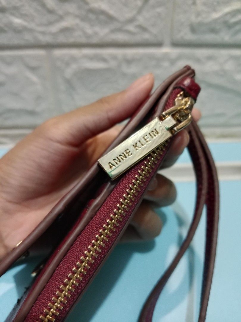 Anne Klein Burgundy Zip Around Wallet (Category: Wallets & Card holders) located in Manila. Submitted by imaiano (Listing ID 1460192296, Image 1). Description: - Burgundy Anne Klein wallet - Hardware still bright - Has ID window, card slots, zip coin pocket, wrist strap - Gold zipper closure - Detachable wrist strap - Ample space for cards and cash - Ideal for everyday use or travel.