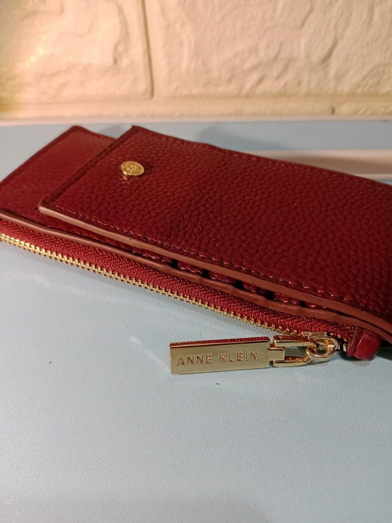 Anne Klein Burgundy Zip Around Wallet (Category: Wallets & Card holders) located in Manila. Submitted by imaiano (Listing ID 1460192296, Image 3). Description: - Burgundy Anne Klein wallet - Hardware still bright - Has ID window, card slots, zip coin pocket, wrist strap - Gold zipper closure - Detachable wrist strap - Ample space for cards and cash - Ideal for everyday use or travel.
