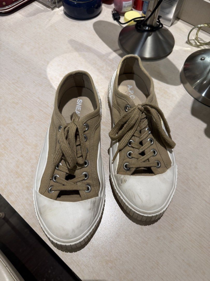 A.P.C. Canvas & White Rubber Sneakers - 8 (Category: Sneakers) located in Quezon City. Submitted by patpotpit (Listing ID 1460172250, Image 2). Description: - A.P.C. canvas sneakers - Tan/khaki color - White rubber toe caps and soles - Classic lace-up style - Visible A.P.C. logo inside - Ideal for casual wear - Soles show some wear and dirt from use.