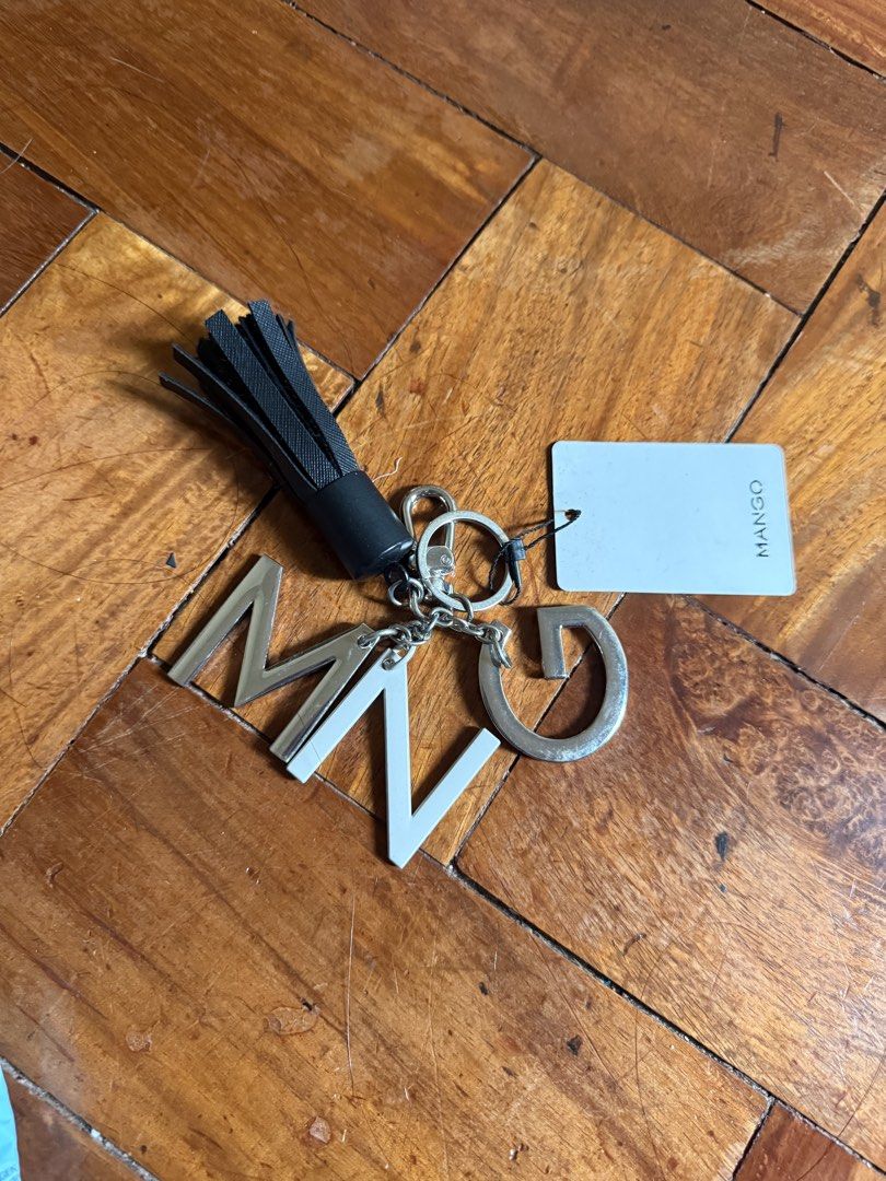 Authentic Mango MNG Letter Tassel Keychain (Category: Handmade Craft) located in Manila. Submitted by ninisegisss (Listing ID 1460110664, Image 1). Description: - Authentic Mango keychain - Features letters M, N, G - Includes a stylish black tassel - Brand new with original tag - Ideal accessory for bags or keys - Adds a touch of flair to your essentials.