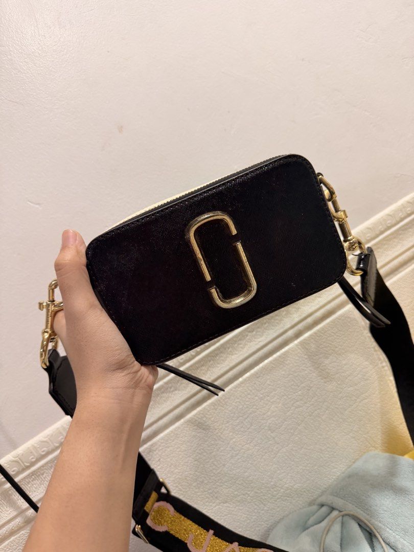 Authentic Marc Jacobs Snapshot Camera bag (Category: Cross-body Bags) located in Caloocan City. Submitted by kimdaljenner (Listing ID 1460205723, Image 3). Description: Authentic Marc Jacobs Snapshot Camera Bag in classic black with gold hardware. ✨ • Color: Black / Gold • Adjustable & detachable wide jacquard strap • Iconic double-J logo hardware • Compact but roomy enough for your essentials • Can be worn crossbody or shoulder • Perfect for eve